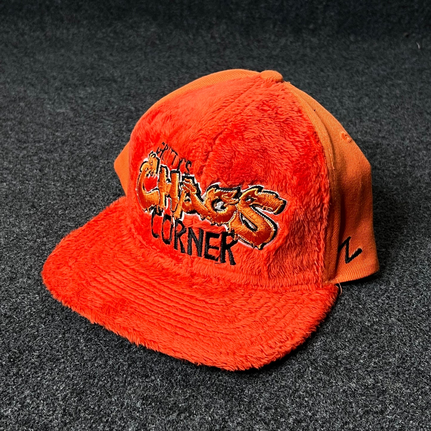 Capelli Sport “Chaos Corner” Fuzzy Flat Cap – Bright Orange