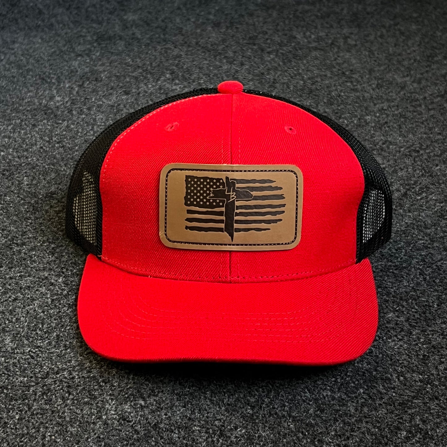 Patriotic Trucker Hat with A Leather Patch featuring A Distressed American Flag and A Knife