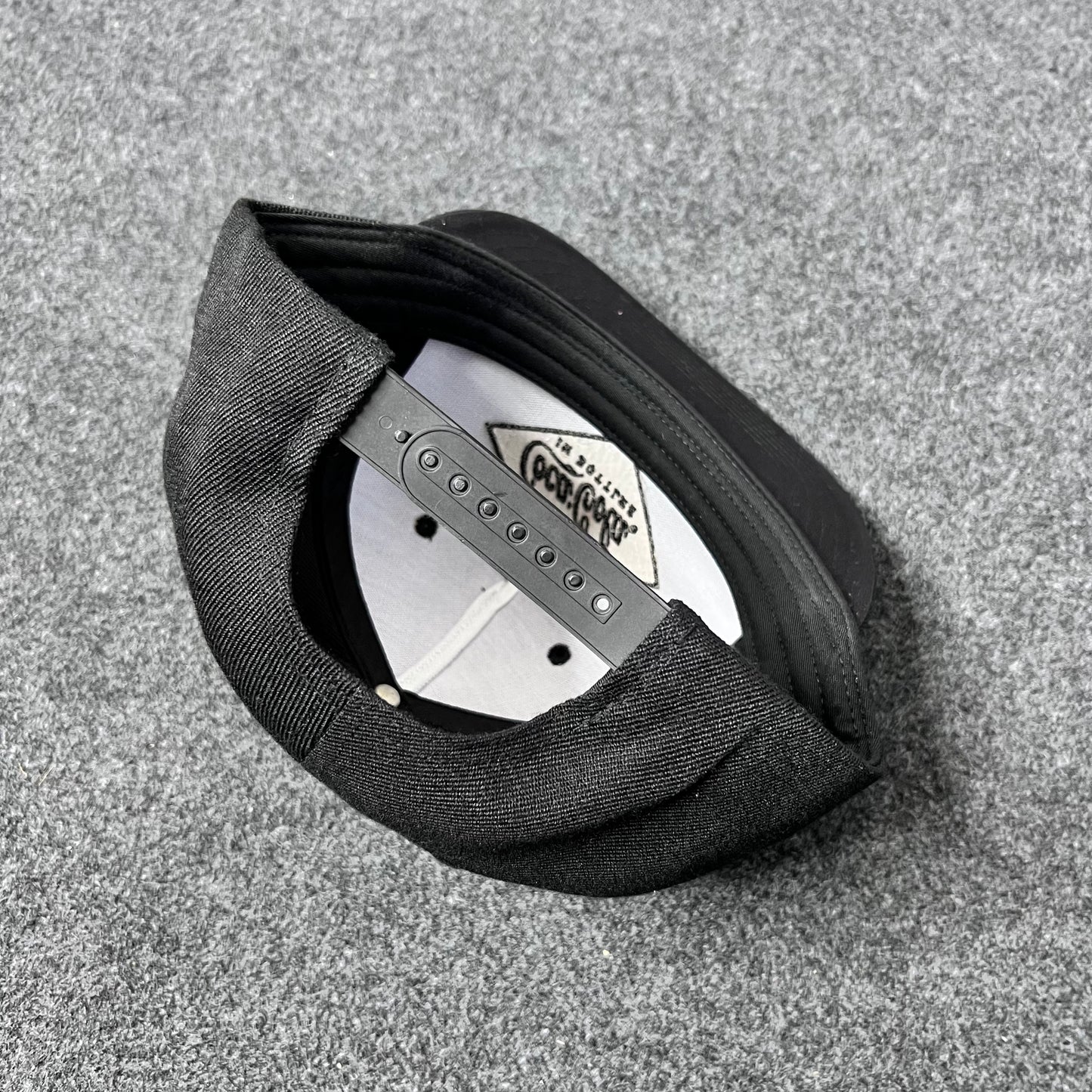 Black Coca-Cola branded Snapback Hat.