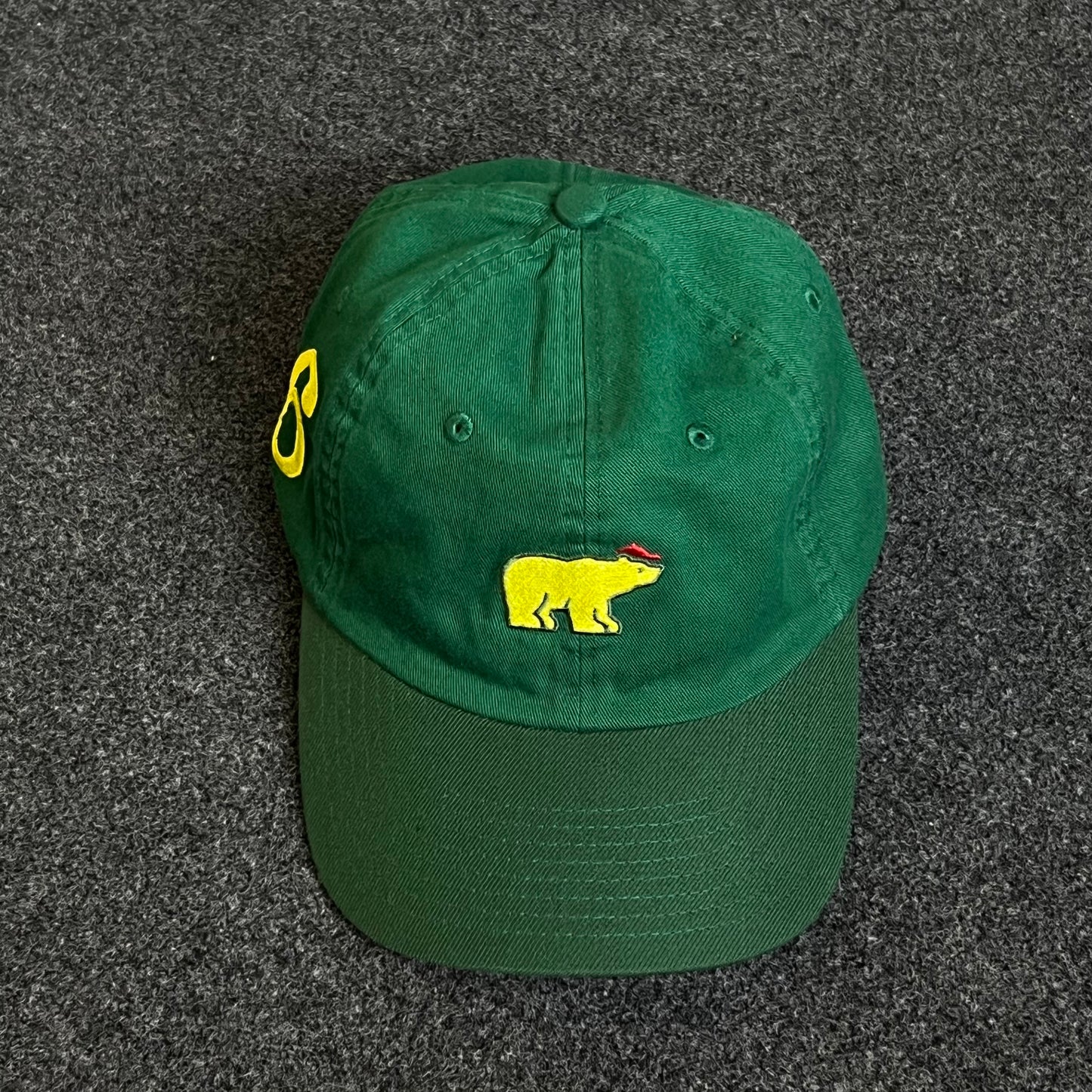 Unstructured Dad Cap – Forest Green with Yellow Bear (Red Accent)