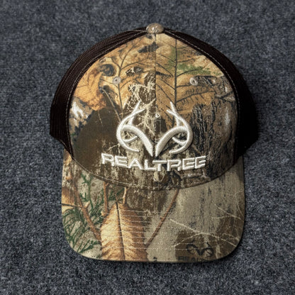 Realtree Men's Camo Hunting Trucker Cap with a 3D Embroidered Antler Logo.
